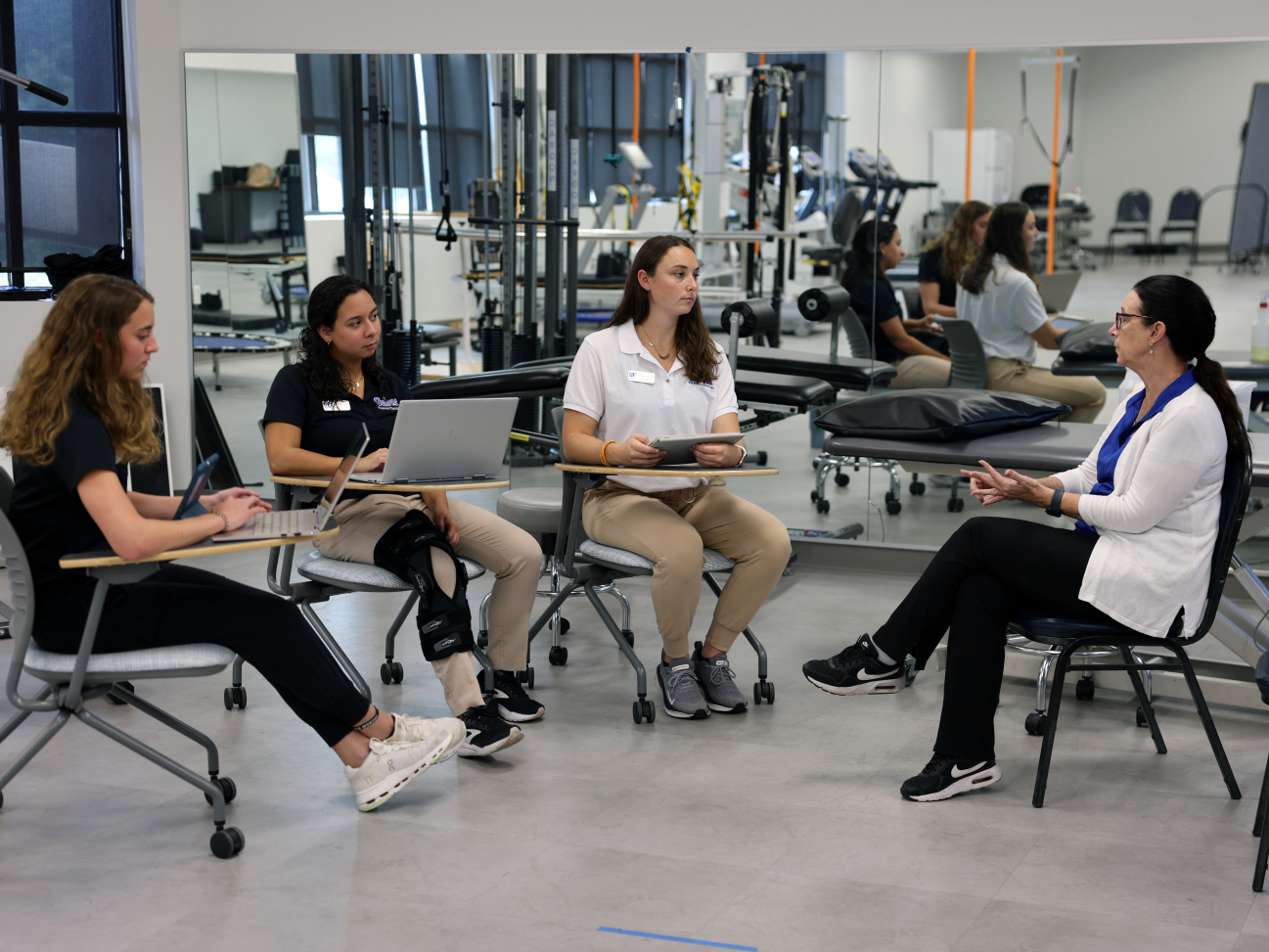 Students prepare for an appointment by reviewing notes with physical therapy professor Kim Dunleavy, Ph.D. Photo by Ashleigh Lucas.