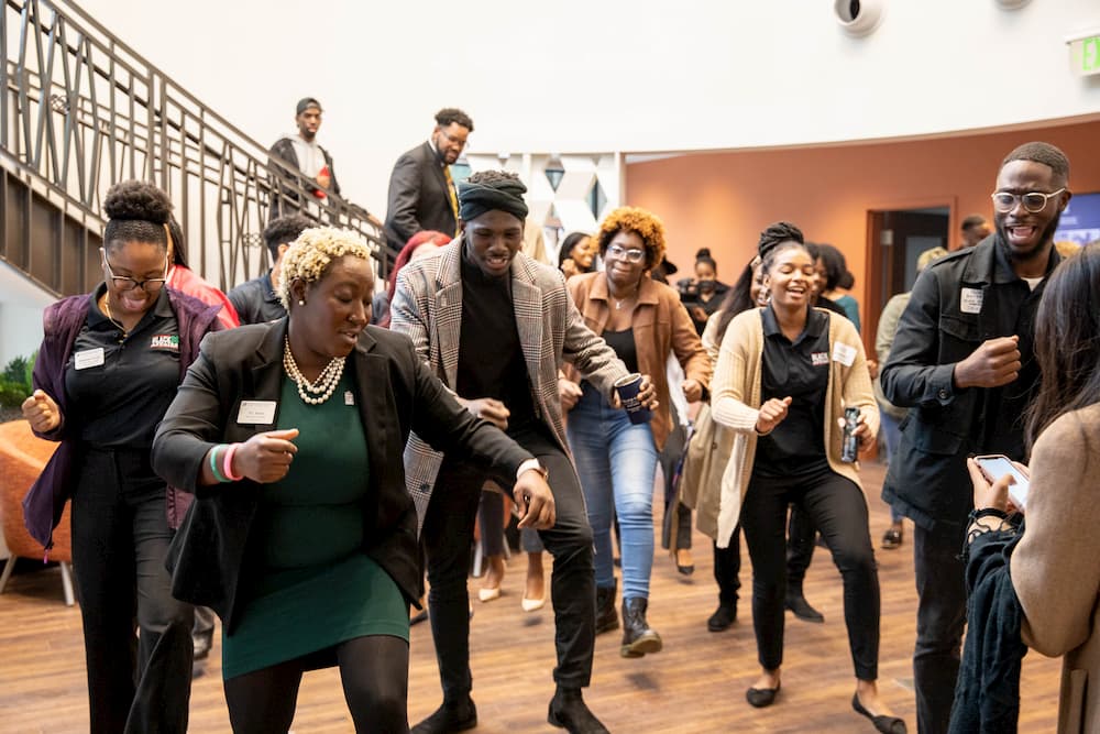 A group of people dances inside the new Institute of Black Culture building