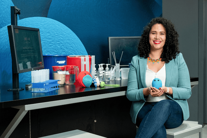 Dr. Ana Maria Porras with her crocheted microbes