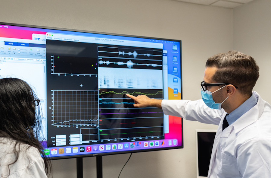 Dr. Matthew Masapollo reviews speech production data in his University of Florida lab.