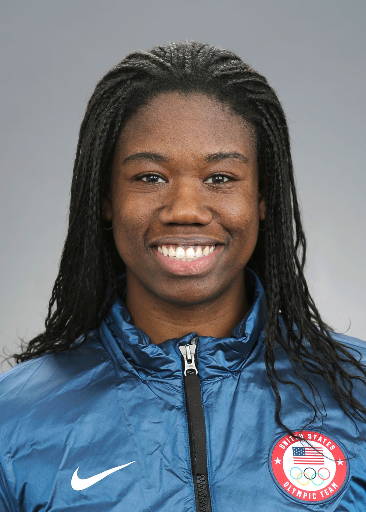 A close up of an African-American woman wearing a blue jacket.