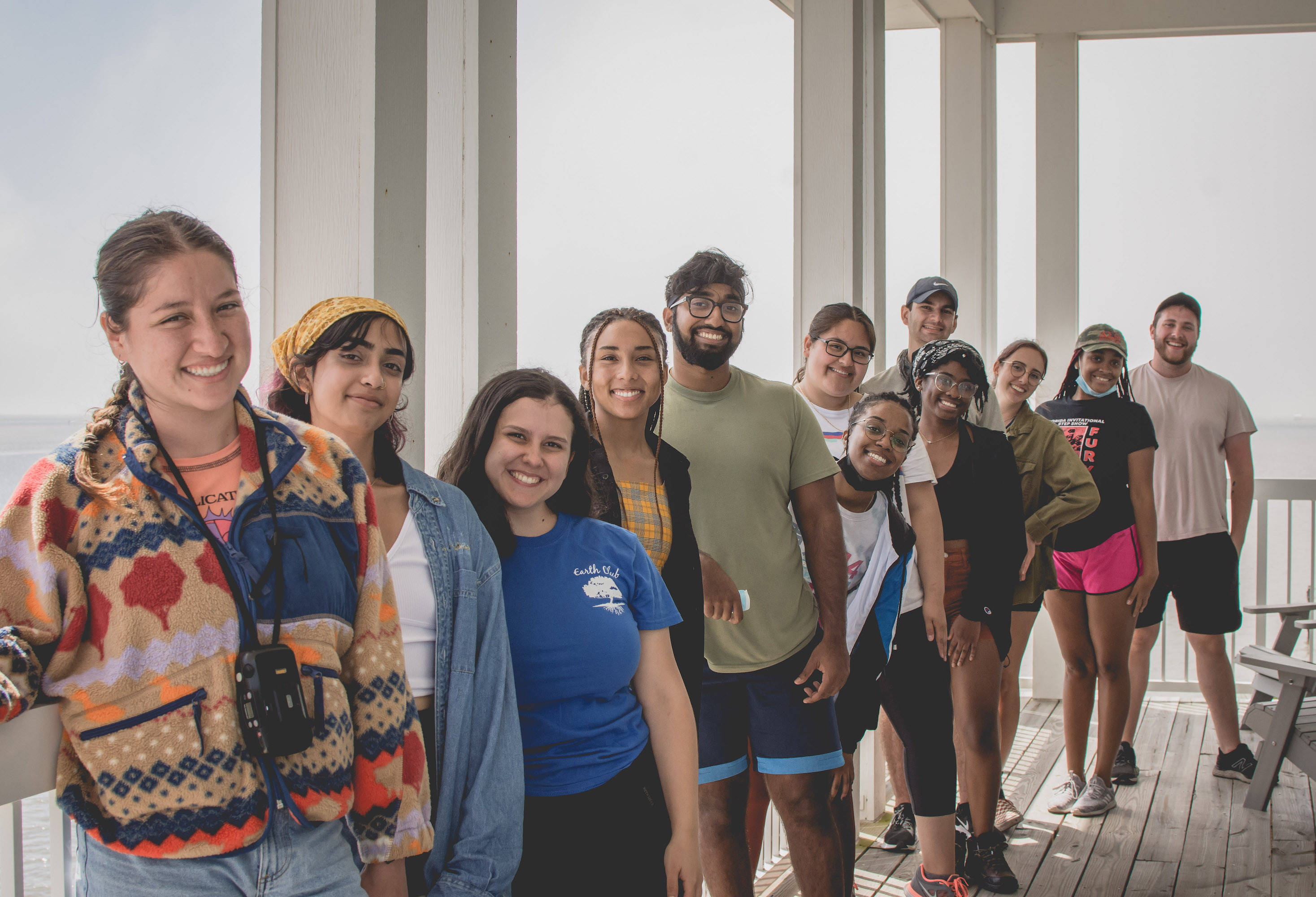 This photo shows a group of students standing on a porch.