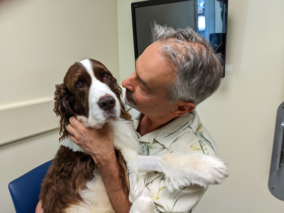 A man holding a dog