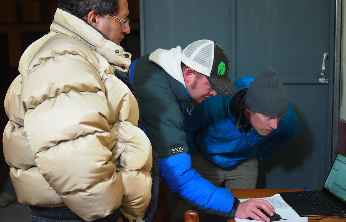 A group of researchers look at a computer.
