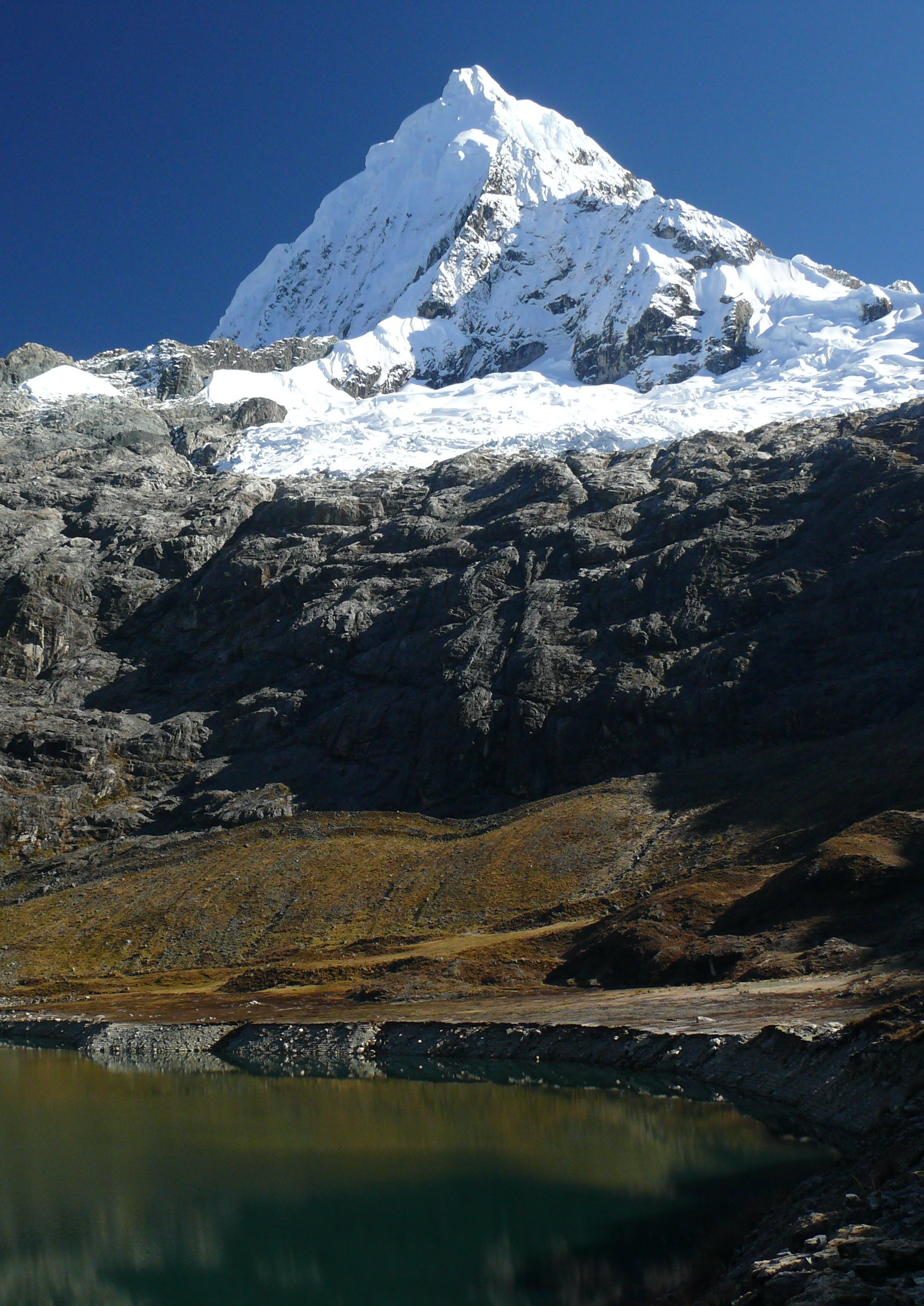 A glacier with a lake in the foreground.