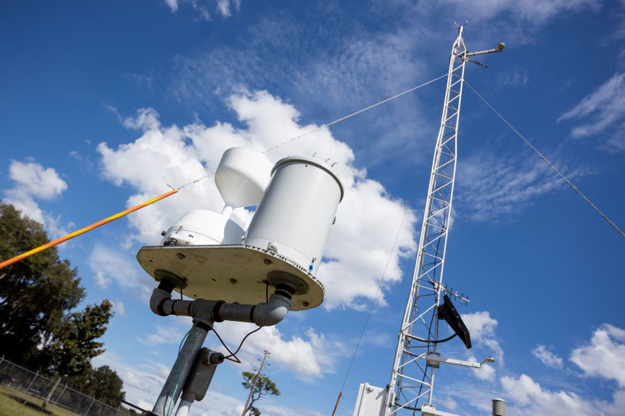 White weather station outside on high pole