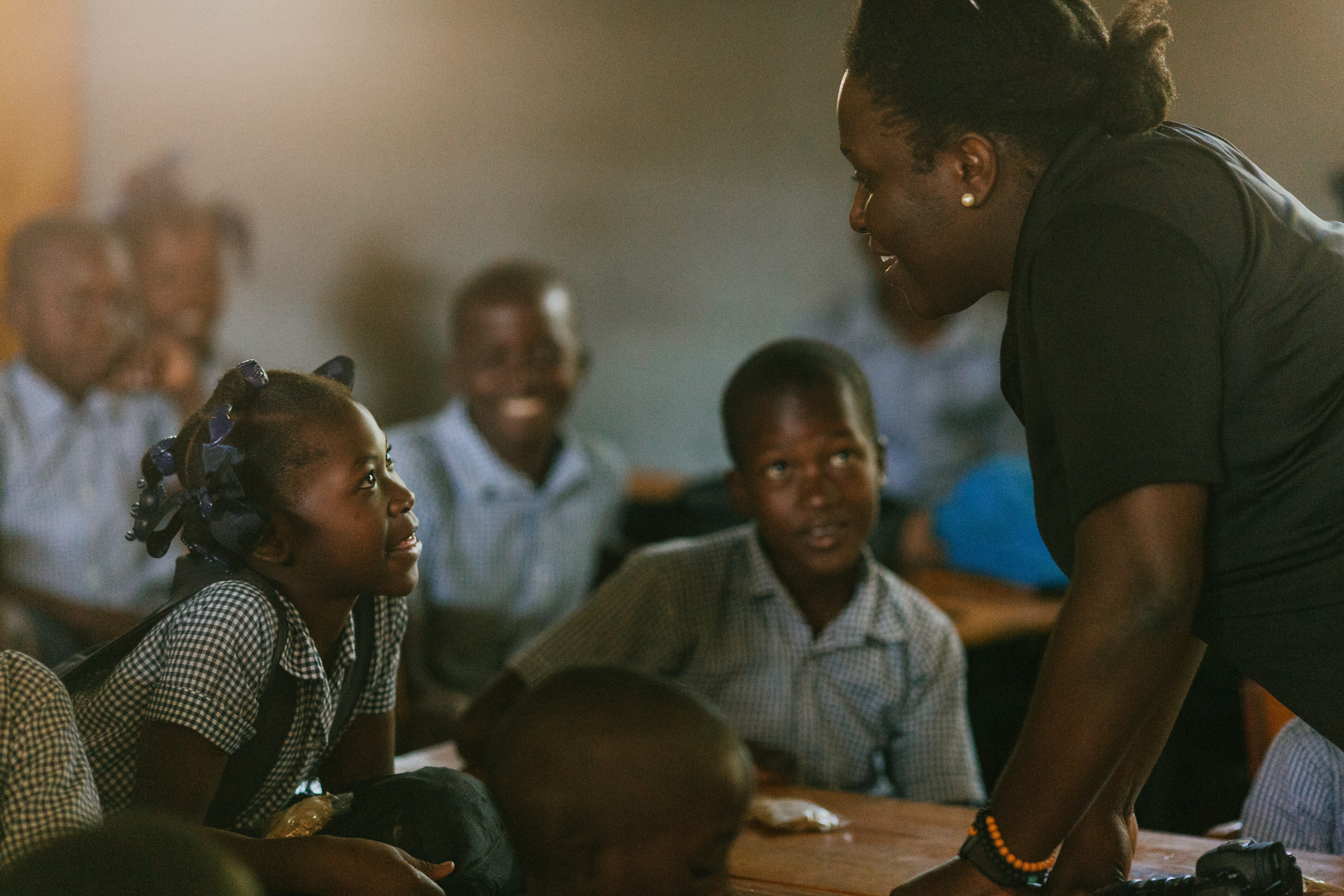 A woman talking with children in Haiti.