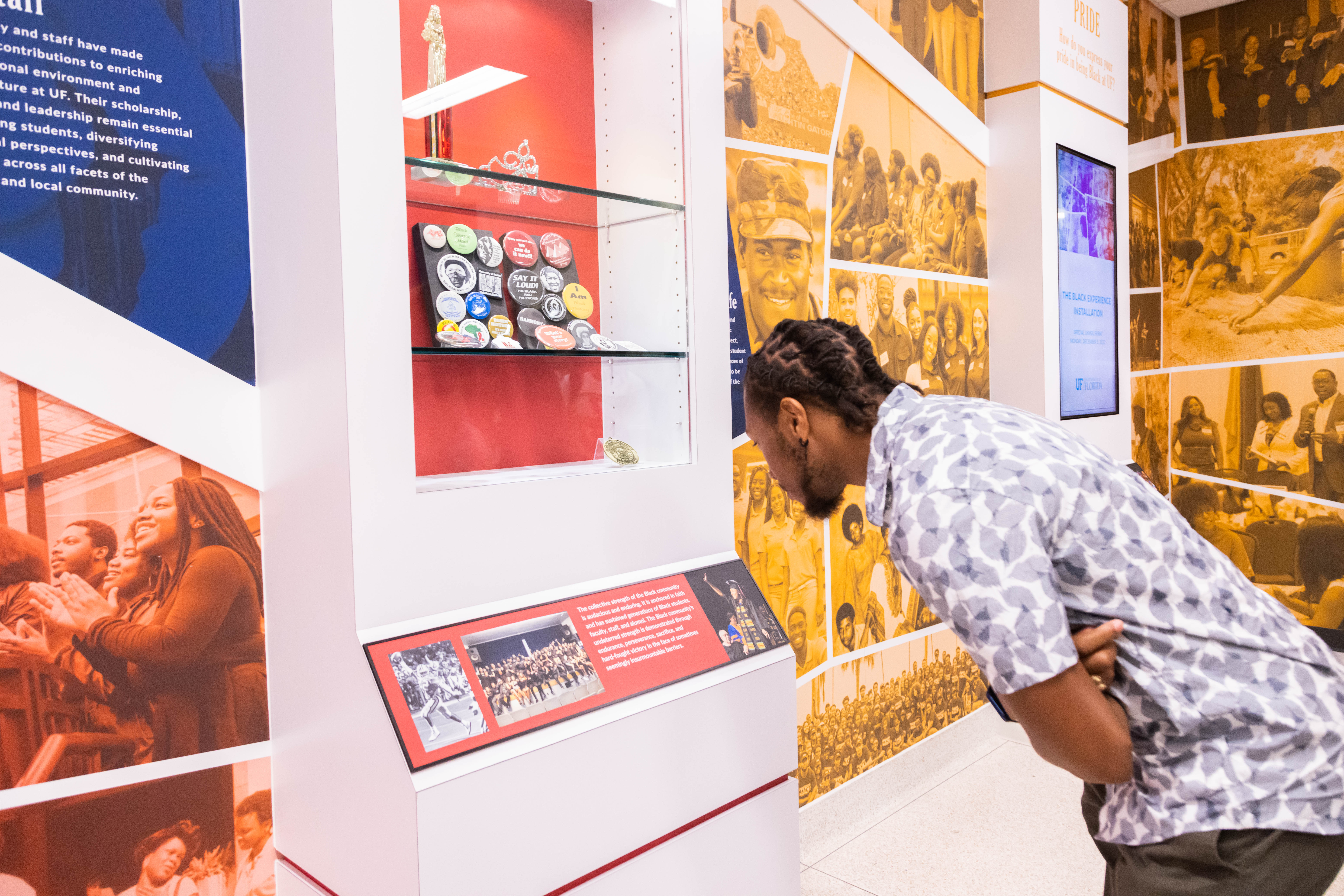 A person bends over to look into a display case. 