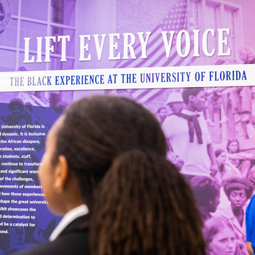 A person looks at a display on the wall.