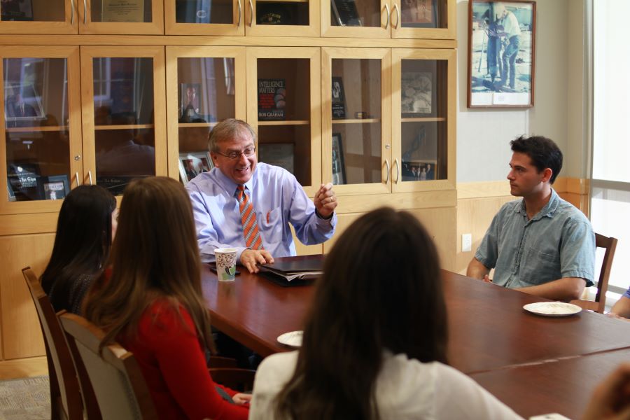 UF president Fuchs addresses group at conference table