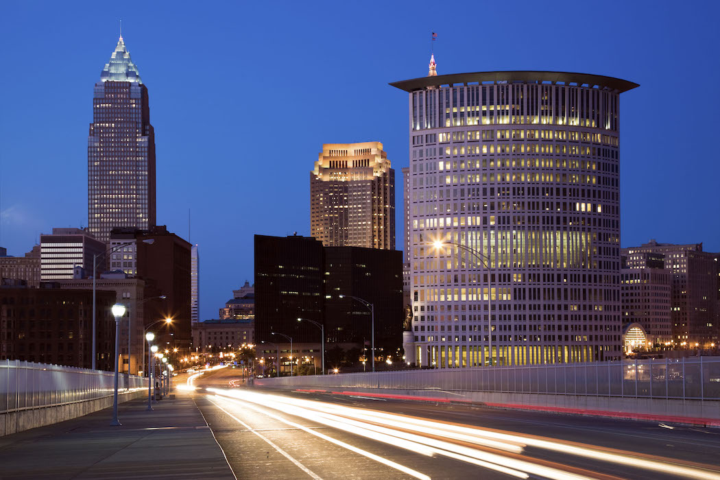 Downtown Cleveland streets at dusk with car headlights and taillights shown in timelapse
