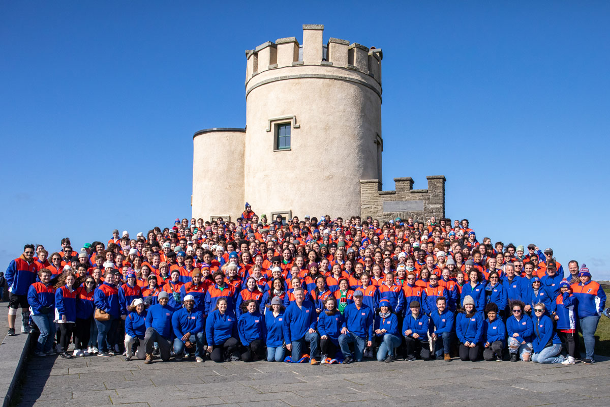 A group photo of a marching band at the Cliffs of Moher