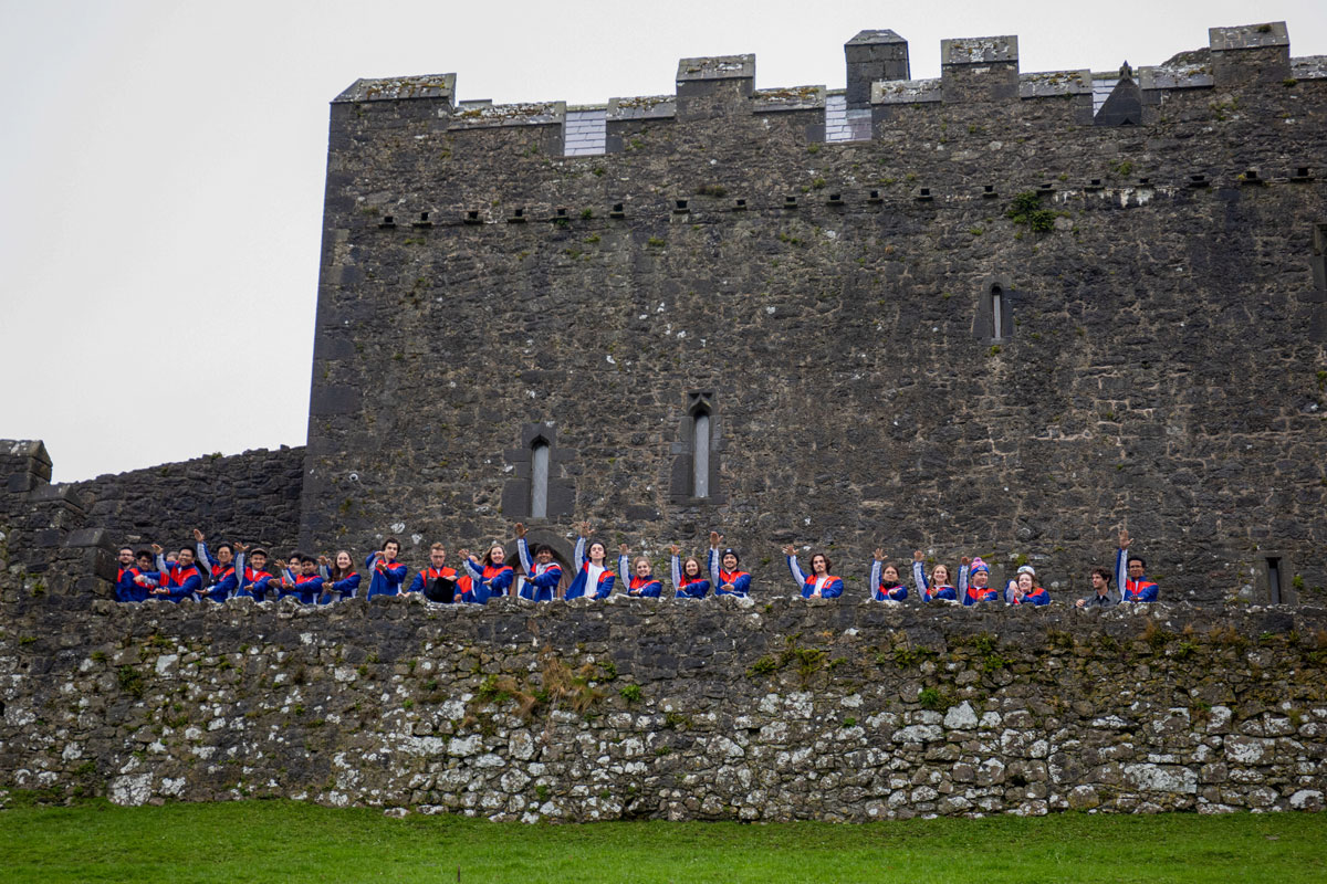 Students do a Gator Chomp at the Rock of Cashel