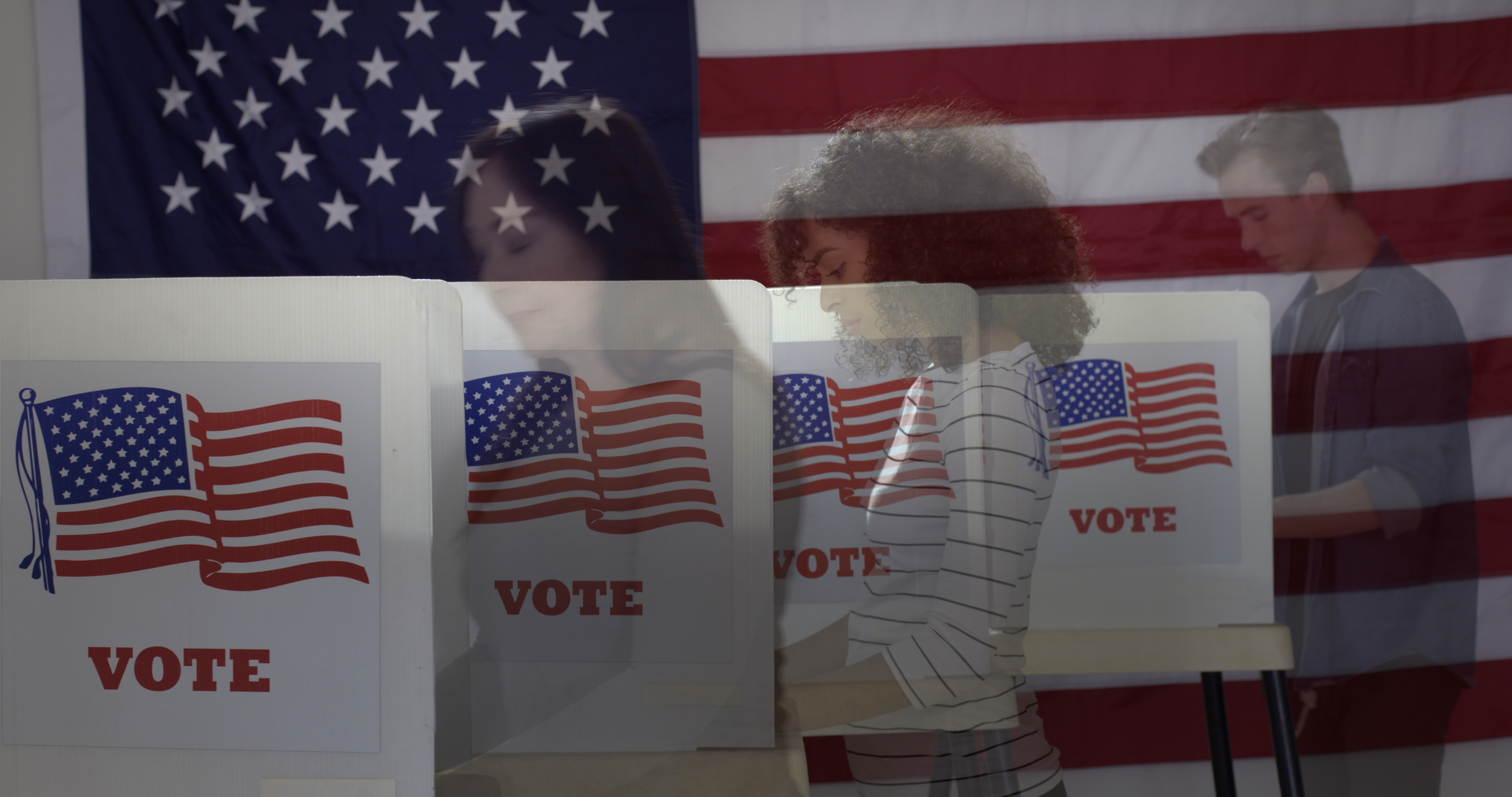 A stock image of voters in a polling location.