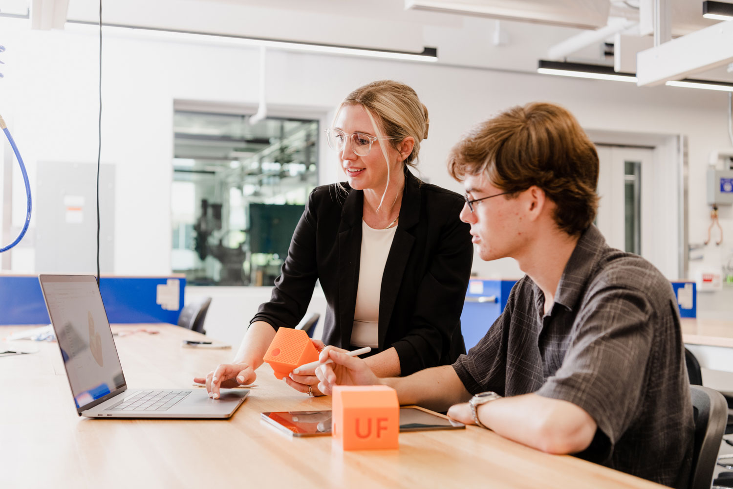 Two students work together in an engineering lab