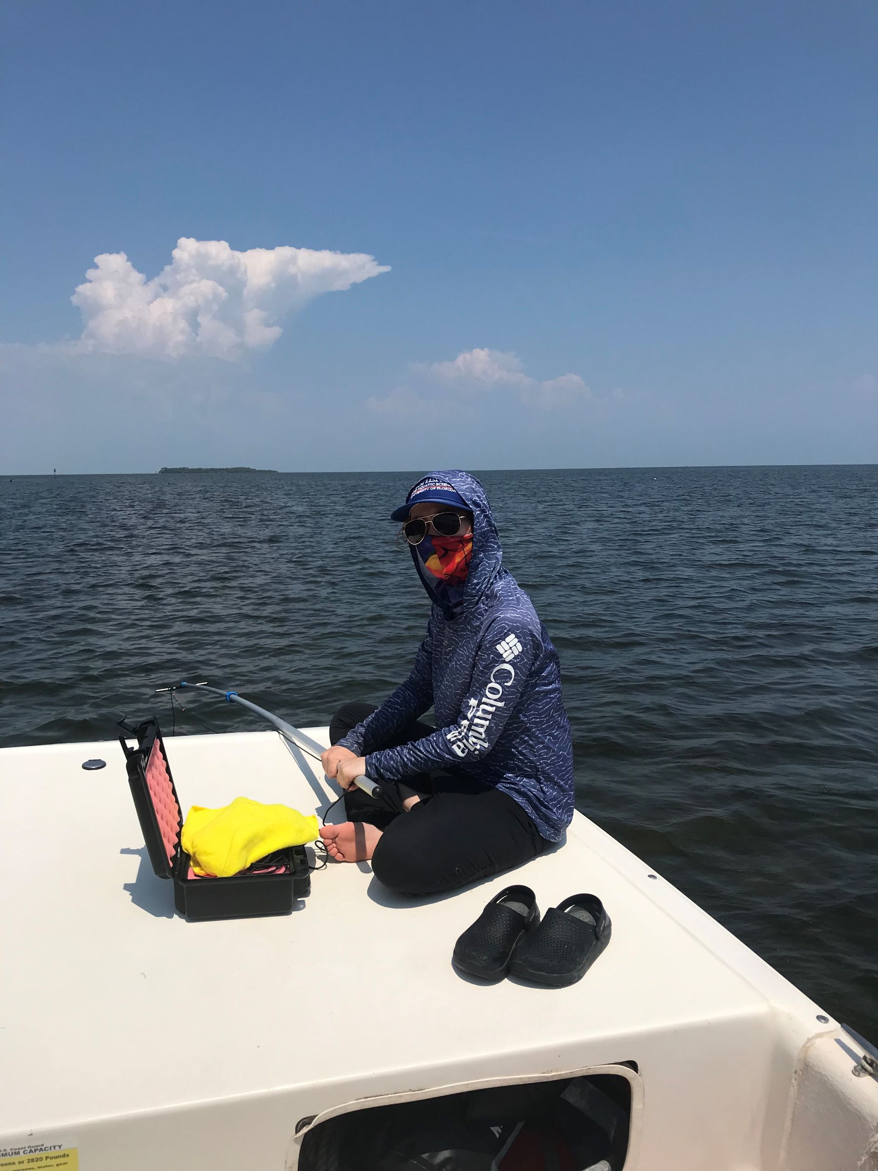 scientist on boat in ocean with sound equipment