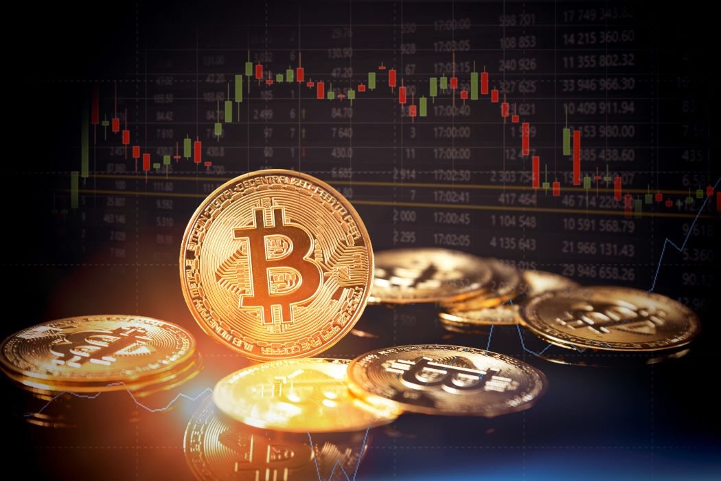 Several artists rendering of gold bitcoins with the bitcoin logo and market prices visible in the background