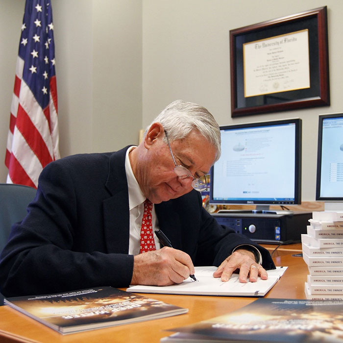 Former Senator Bob Graham works from his desk at Pugh Hall.