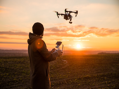A stock image of a person flying a drone.