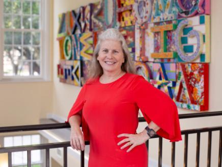 A head shot of a woman in a red dress.