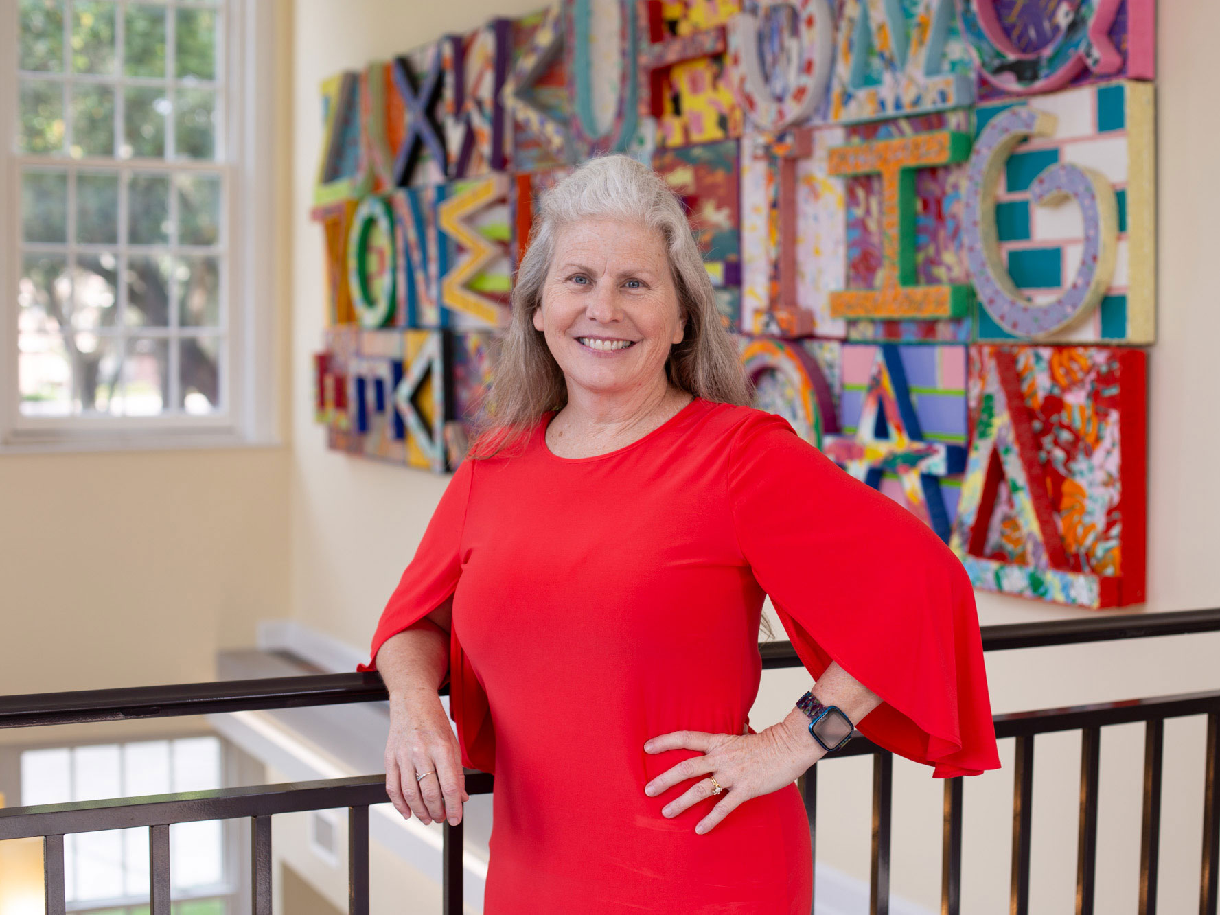 A head shot of a woman in a red dress.