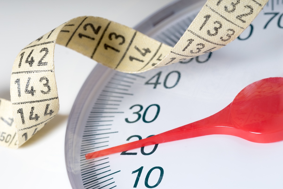 close up of a scale with tape measure draped over