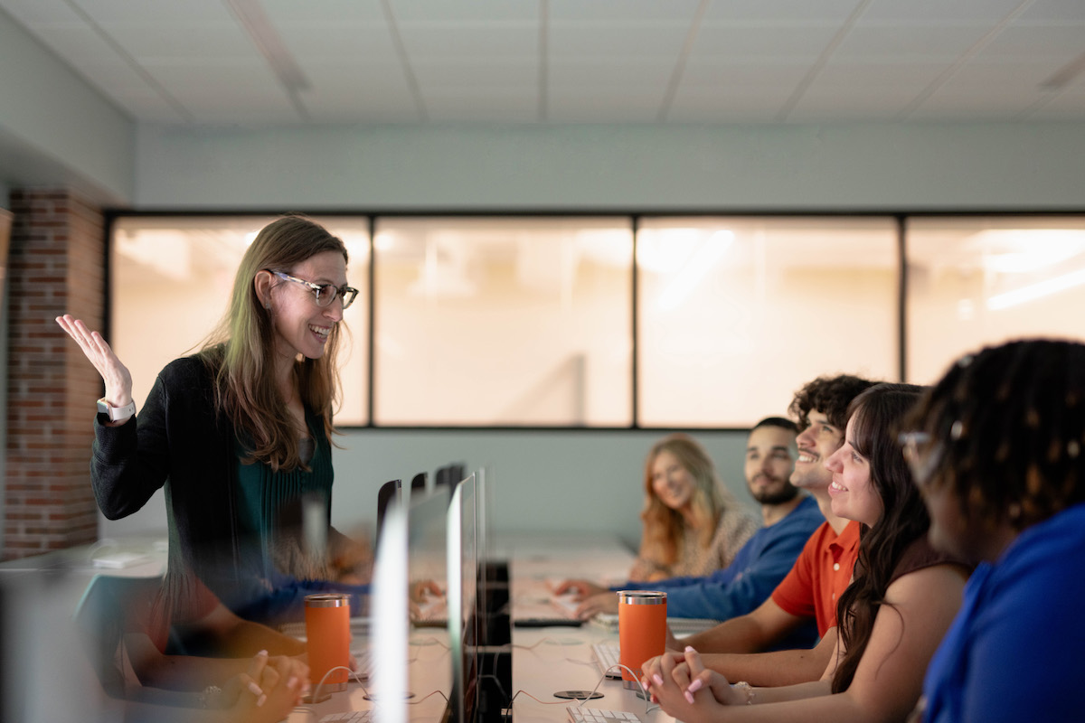 A teacher in a classroom talking to students.