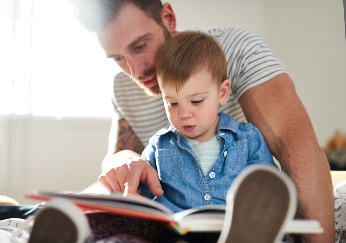 A man reads to a toddler
