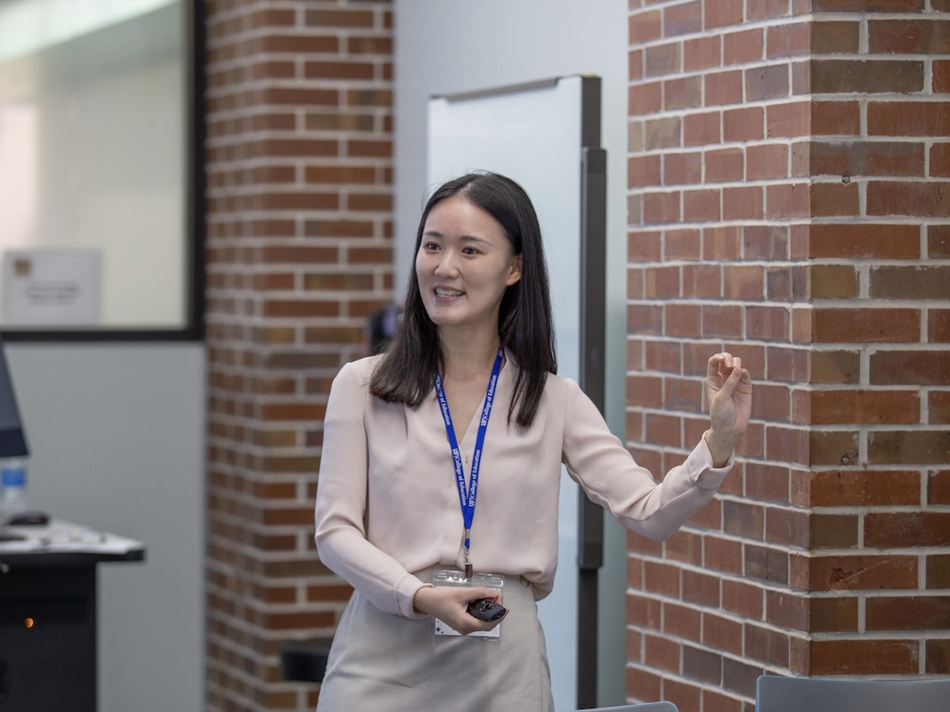 A photo of female researcher during presentation.