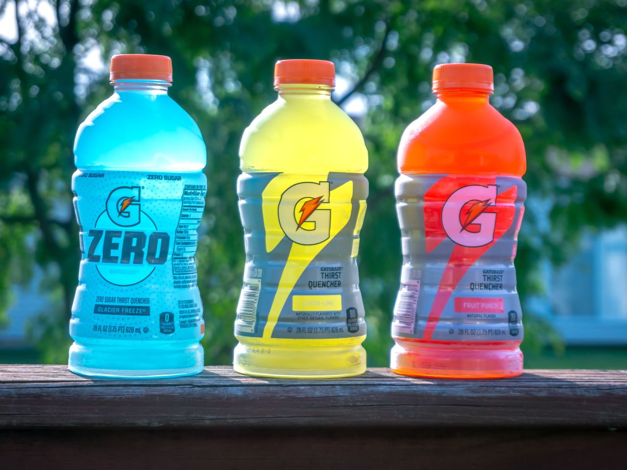 Three Gatorade bottles outside on a table