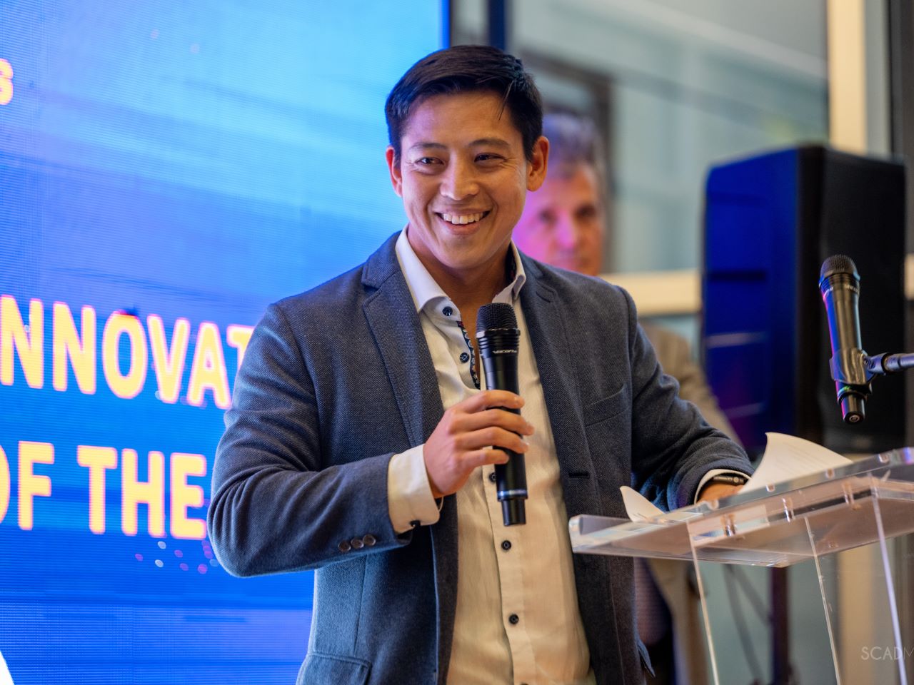 Eric Wang speaking into a microphone