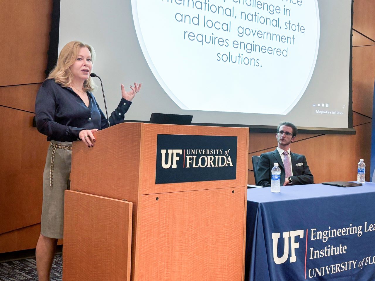 Pegeen Hanrahan speaks at a lectern
